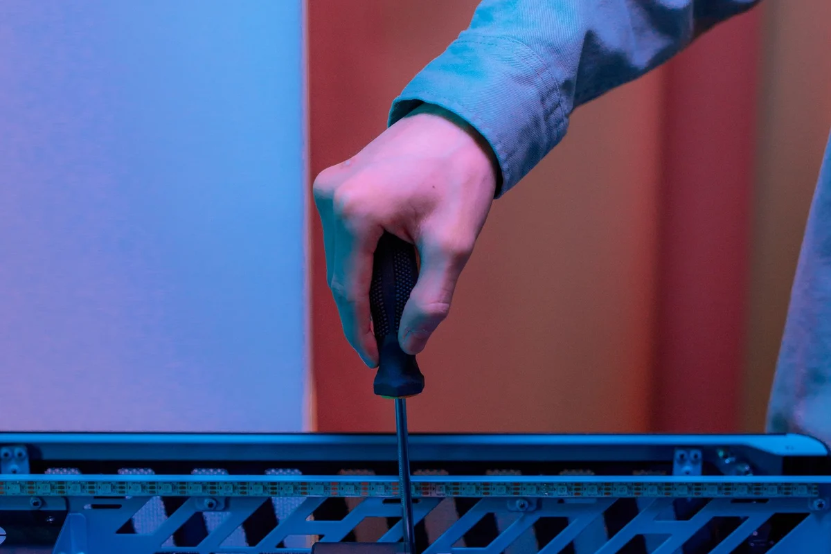 A screw being fastened to a PC case