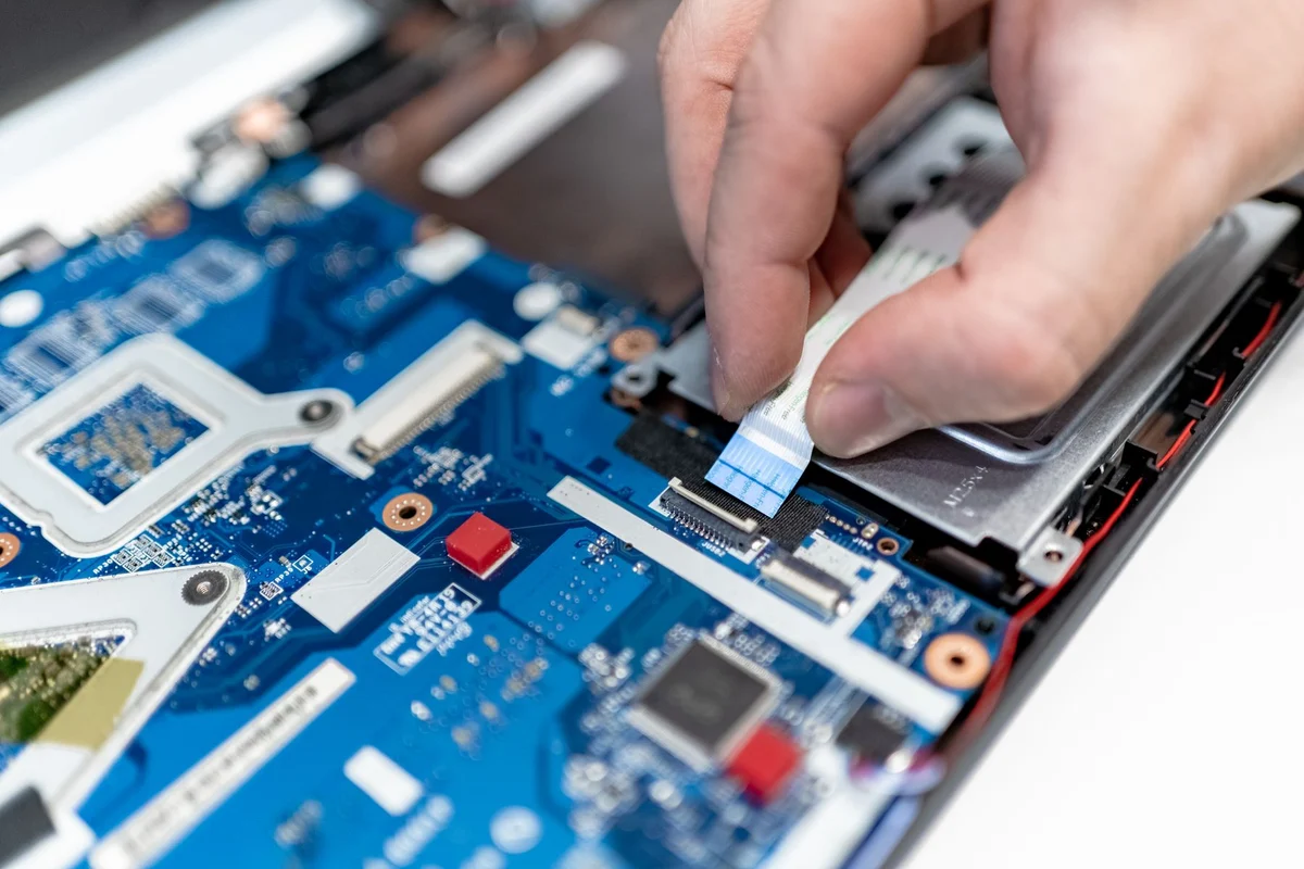 Person checking the internal connections of a laptop