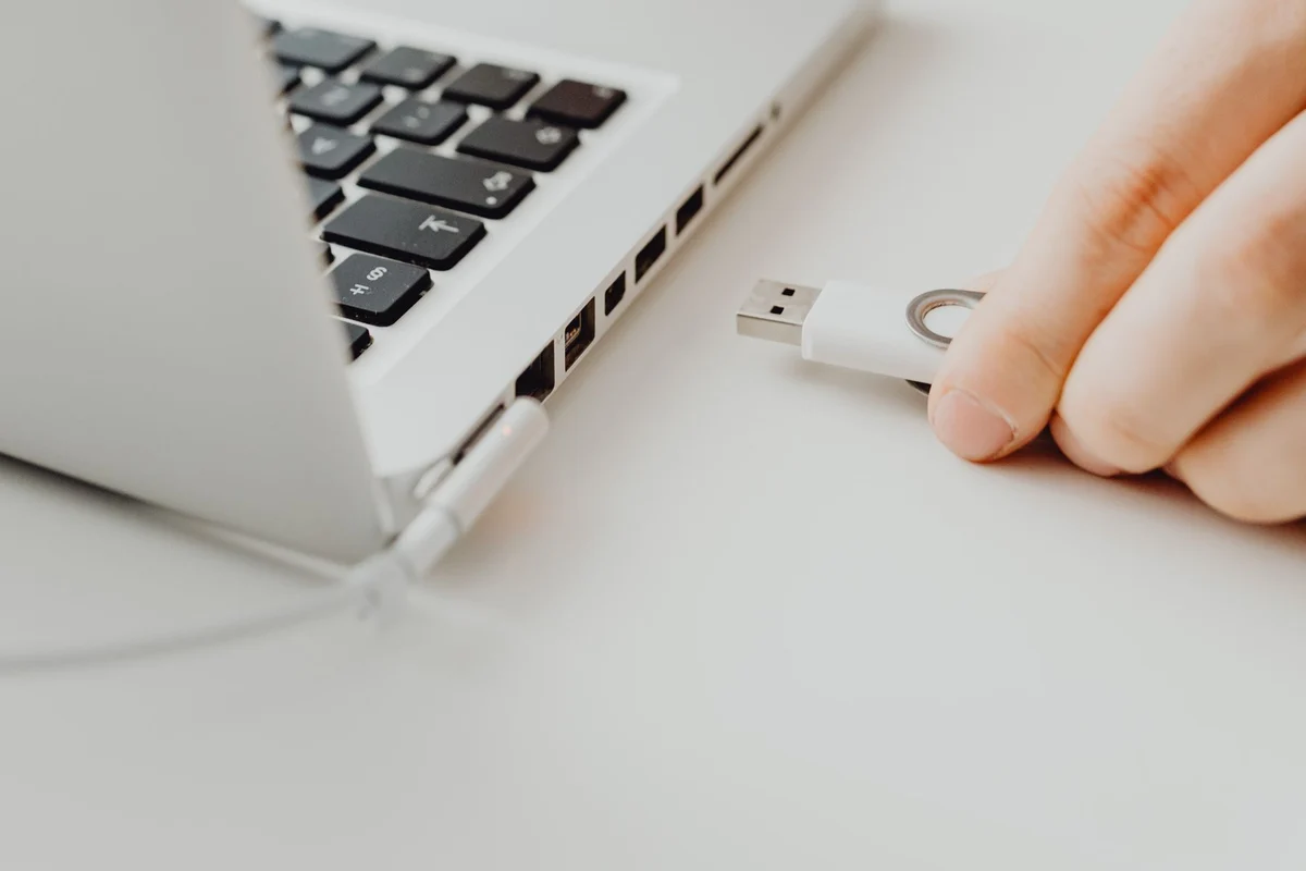 Small USB flash drive held in a hand