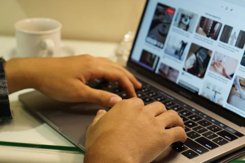 Hands on a laptop keyboard