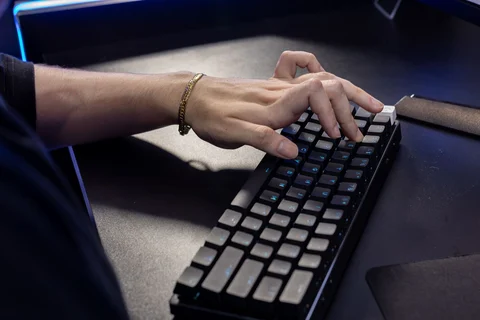 Hände tippen auf einer mechanischen Tastatur