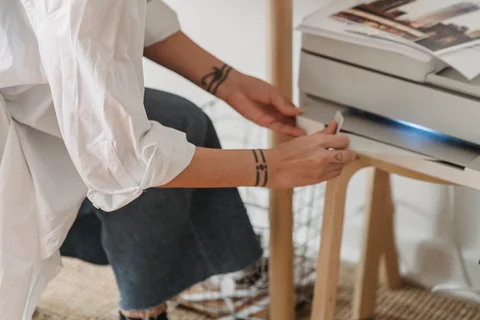Person beside a compact printer