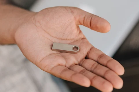Hand holding a USB flash drive