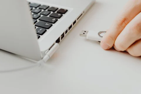 Small USB flash drive held in a hand
